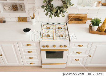 Modern new light wooden kitchen interior with white furniture and kitchen utensils Modern new light wooden kitchen interior with white furniture and kitchen utensils 101203296