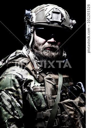 Close up, low key half length portrait of bearded commando fighter, army special forces soldier, private military company mercenary. Masculinity, determination and strength Close up, low key half length portrait of bearded commando fighter, army special forces soldier, private military company mercenary. Masculinity, determination and strength 101203326