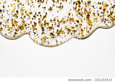 Liquid gel abstract cosmetic background. Smear of transparent moisturizing product with golden particles Liquid gel abstract cosmetic background. Smear of transparent moisturizing product with golden particles 101203815