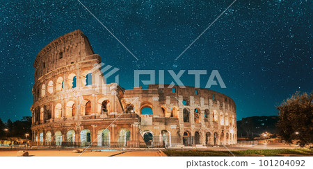 Rome, Italy. Colosseum Also Known As Flavian Amphitheatre In Evening Or Night Time. Travel Italy. Bright Blue Night Sky. Amazing Night Starry Sky Background Rome, Italy. Colosseum Also Known As Flavian Amphitheatre In Evening Or Night Time. Travel Italy. Bright Blue Night Sky. Amazing Night Starry Sky Background 101204092