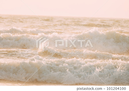 Evening sunlight sunshine above sea. Amazing landscape scenery. Sea ocean water surface with foaming small waves. Sea ocean water surface with Crashing waves. Copy space. Nature background Evening sunlight sunshine above sea. Amazing landscape scenery. Sea ocean water surface with foaming small waves. Sea ocean water surface with Crashing waves. Copy space. Nature background 101204100