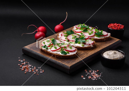 Delicious sandwich or bruschetta with cream cheese radish and green onions Delicious sandwich or bruschetta with cream cheese radish and green onions 101204311