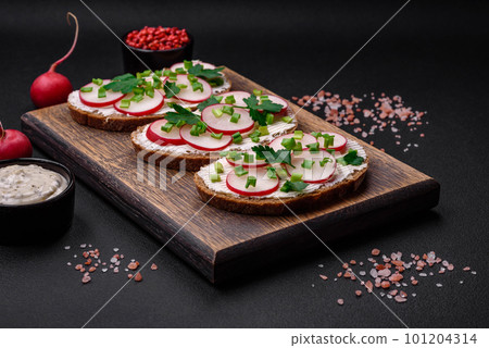 Delicious sandwich or bruschetta with cream cheese radish and green onions Delicious sandwich or bruschetta with cream cheese radish and green onions 101204314