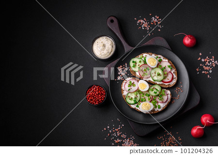 Delicious sandwich or bruschetta with cream cheese radish and green onions Delicious sandwich or bruschetta with cream cheese radish and green onions 101204326