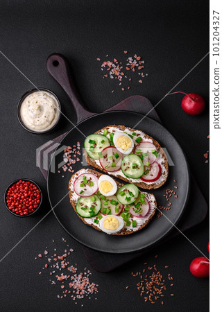 Delicious sandwich or bruschetta with cream cheese radish and green onions Delicious sandwich or bruschetta with cream cheese radish and green onions 101204327