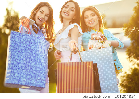 Beautiful girls with packages after shopping. Girl walking around city after shopping. good mood. Beautiful girls with packages after shopping. Girl walking around city after shopping. good mood. 101204834
