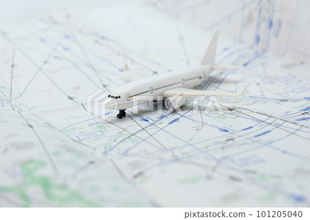 Miniature model airplane on a flight sectional map with focus on the foreground, background blur. High quality photo 101205040