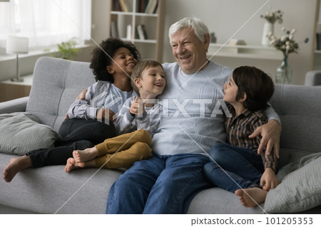 Cheerful old retired granddad hugging, cuddling cute little multiethnic grandsons Cheerful old retired granddad hugging, cuddling cute little multiethnic grandsons 101205353