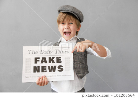 Newsboy shouting against grunge wall background. Boy selling fake news 101205564