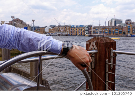Young man in China Wharf London wearing fashion watch 101205740