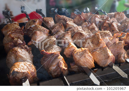 Shish kebab roasting on the grill. BBQ party. Close-up Shish kebab roasting on the grill. BBQ party. Close-up 101205967