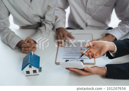 Happy couple signing a contract with real estate agent. renters tenants sign mortgage loan investment agreement or rental insurance contract meeting realtor lender landlord making real estate sale Happy couple signing a contract with real estate agent. renters tenants sign mortgage loan investment agreement or rental insurance contract meeting realtor lender landlord making real estate sale 101207656