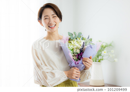 A woman receiving a bouquet A woman receiving a bouquet 101209499