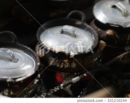 The making of a traditional Indonesian cake, originating from the Java region, named "surabi" is made from rice flour and placed in a small frying pan and topped with various toppings such as cheese. The making of a traditional Indonesian cake, originating from the Java region, named "surabi" is made from rice flour and placed in a small frying pan and topped with various toppings such as cheese. 101210244