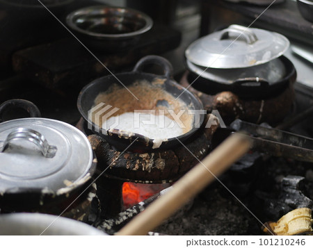 The making of a traditional Indonesian cake, originating from the Java region, named "surabi" is made from rice flour and placed in a small frying pan and topped with various toppings such as cheese. The making of a traditional Indonesian cake, originating from the Java region, named "surabi" is made from rice flour and placed in a small frying pan and topped with various toppings such as cheese. 101210246