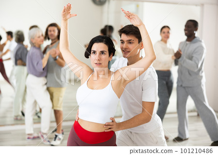 Adult couple of dancers learns partner dance 101210486