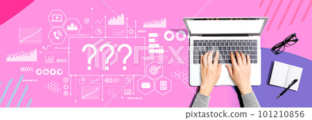 Question marks with person using a laptop 101210856