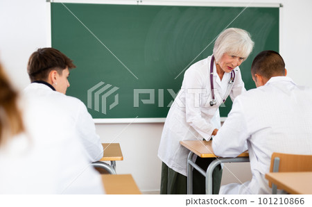 Professor reading lecture to group of medical students Professor reading lecture to group of medical students 101210866