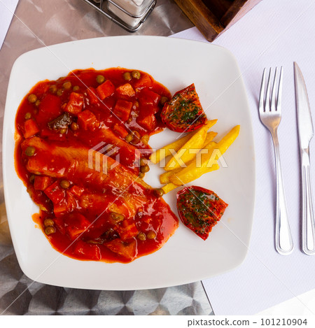 Baked tilapia with vegetable sauce, potatoes and sun-dried tomatoes 101210904