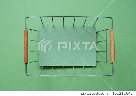 Empty basket with copy space on green background. top view 101211642