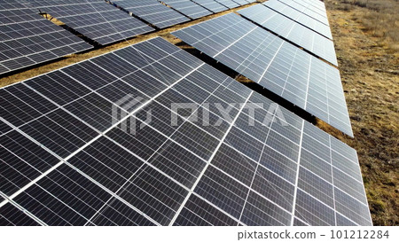 Solar power plant. Flight over modules of solar power station on sunny day. Alternative green electricity power. New modern technology. Renewable electrical energy. photovoltaic modules photobatteries 101212284