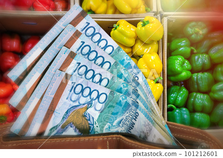 Rising prices for vegetables and agricultural products in Kazakhstan. Tenge in a wallet against the background of a counter with bell peppers Rising prices for vegetables and agricultural products in Kazakhstan. Tenge in a wallet against the background of a counter with bell peppers 101212601