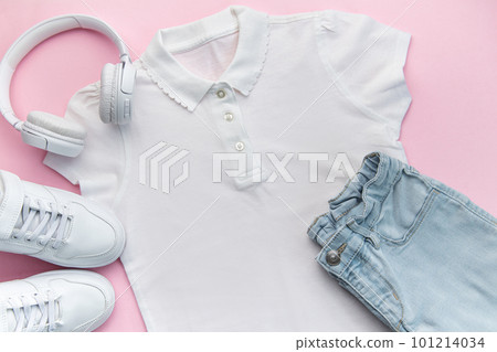 Child's t-shirt, shoes and headphones on pink backgrund Child's t-shirt, shoes and headphones on pink backgrund 101214034