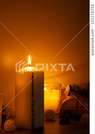Candle with advent calendar Traditional Burning Christmas Wax Candles with numbers counting down for Christmas. Beautiful Advent At Home. Festive Candlelight And Dark Background 101216558