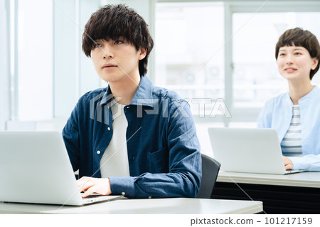 Young men and women receiving a lecture 101217159