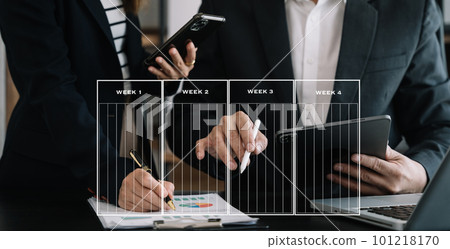 Business team hand Project manager working and update tasks and Gantt chart scheduling virtual diagram.with smart phone, tablet and laptop in office. 101218170