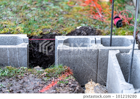 the foundation of the house is made of concrete blocks bound with metal armature 101219280