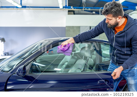 manual cleaning of luxury car windows with a microfiber towel in the garage manual cleaning of luxury car windows with a microfiber towel in the garage 101219325