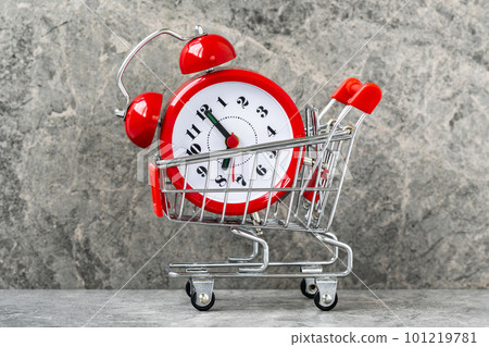 Buying time concept with clock and shopping cart Buying time concept with clock and shopping cart 101219781