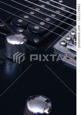 Switches on a black electric guitar closeup 101219981