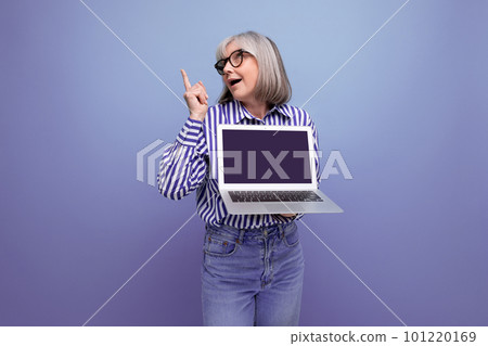 modern pensioner woman learning new profession using laptop with mockup on bright studio background modern pensioner woman learning new profession using laptop with mockup on bright studio background 101220169