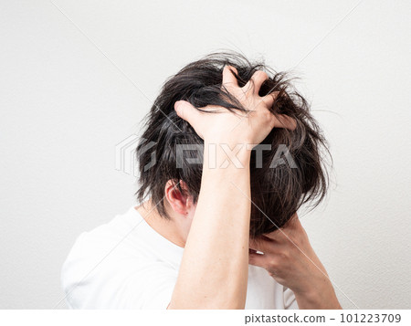 man holding his head with both hands 101223709