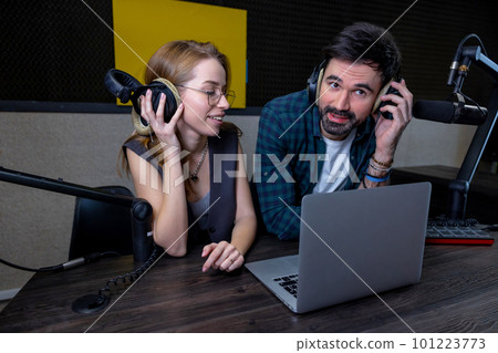 Two people at the studio preparing a radio program 101223773