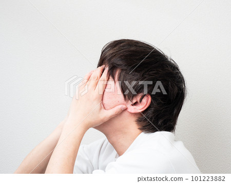 man holding his head with both hands man holding his head with both hands 101223882