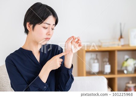 Worried young woman looking at tampons Worried young woman looking at tampons 101225968