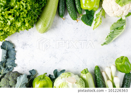 Frame of green raw vegetables on white background. Top view of healthy organic food. Copy space 101226363