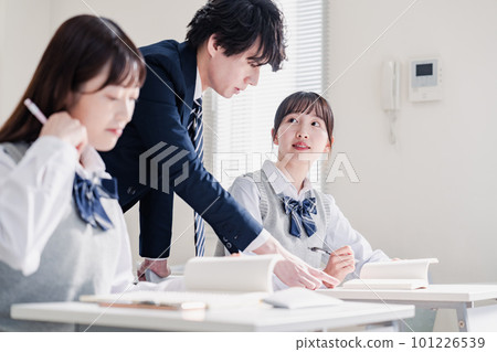 High school student asking a question to the teacher in the classroom High school student asking a question to the teacher in the classroom 101226539