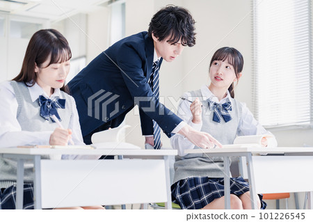 High school student asking a question to the teacher in the classroom 101226545