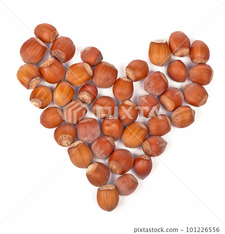Healthy food, vegetarianism. dried hazelnuts laid out in a heart shape on a white background Healthy food, vegetarianism. dried hazelnuts laid out in a heart shape on a white background 101226556