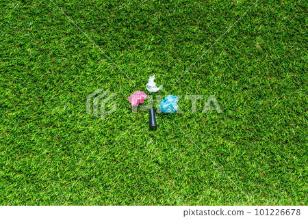 Mouthpiece for shisha om the green grass backround. Plastic waste concept. Plastic trash garbage, save nature. Parts of hookah, tobacco Hookah Shisha Mouthpiece on grass background. 101226678