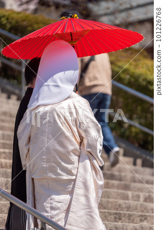 A bride in pure white with a red umbrella waiting for the groom A bride in pure white with a red umbrella waiting for the groom 101226768