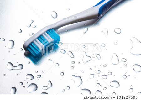 Blue toothbrush on a gray background closeup Blue toothbrush on a gray background closeup 101227595