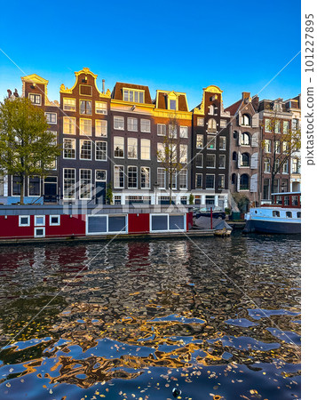 Damrak narrow houses at night in Amsterdam center, Netherlands 101227895