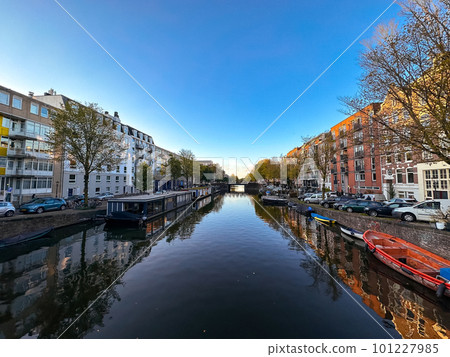 Amsterdam canal view with boats and bicycles at sunset, Netherlands Amsterdam canal view with boats and bicycles at sunset, Netherlands 101227985