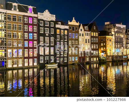 Damrak narrow houses at night in Amsterdam center, Netherlands Damrak narrow houses at night in Amsterdam center, Netherlands 101227986