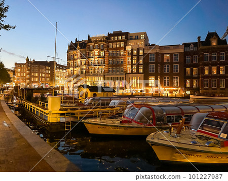 Damrak narrow houses at night in Amsterdam center, Netherlands 101227987